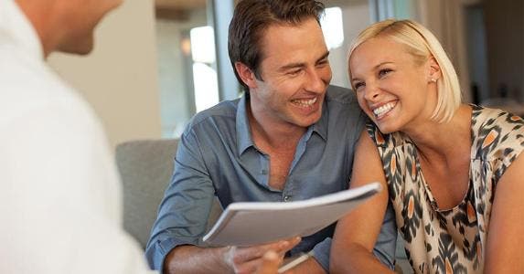 When sharing taxes might not be a good idea Laughing couple holding paperwork | Sam Edwards/Getty Images