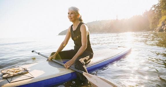 How single person can minimize taxes in retirement Senior woman sitting on kayak | Hero Images/Getty Images