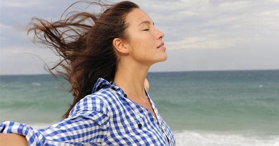 Prevent and resolve IRS problems Woman standing in the wind by the shore | mangostock/Getty Images