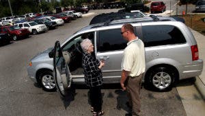 Woman and man talking at a car lot