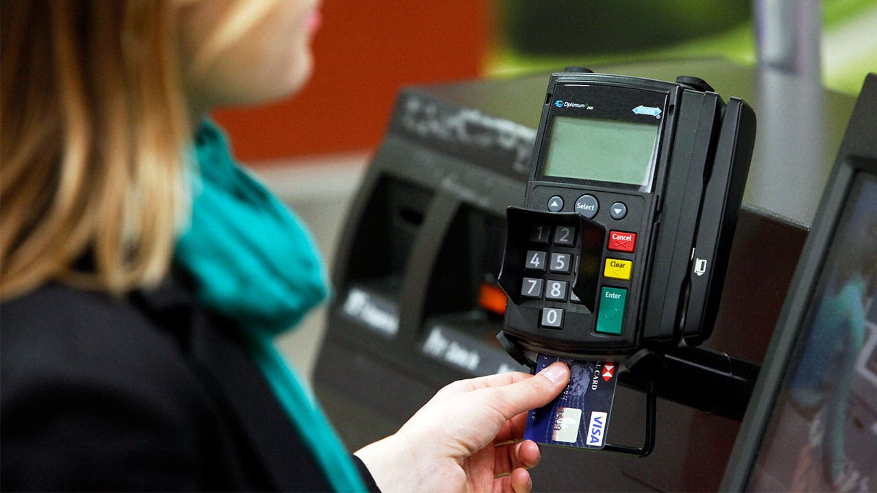 Woman using a chip credit card reader