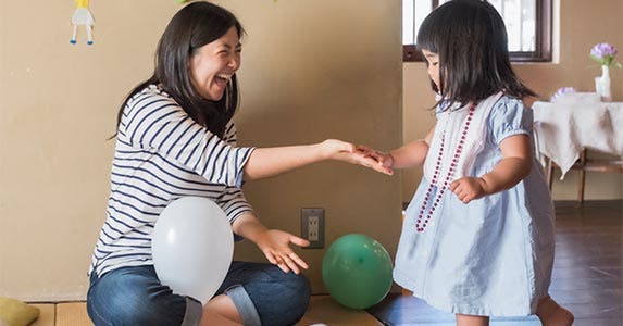 Mother playing with young daughter