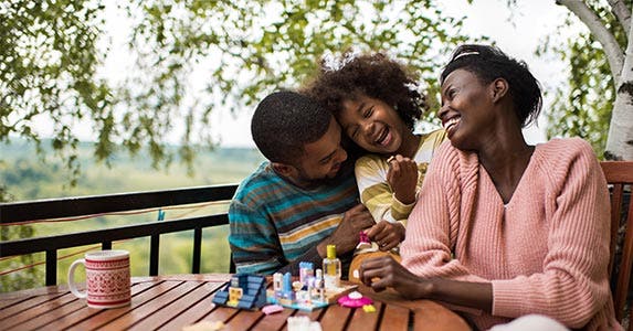 Family sitting outside at table