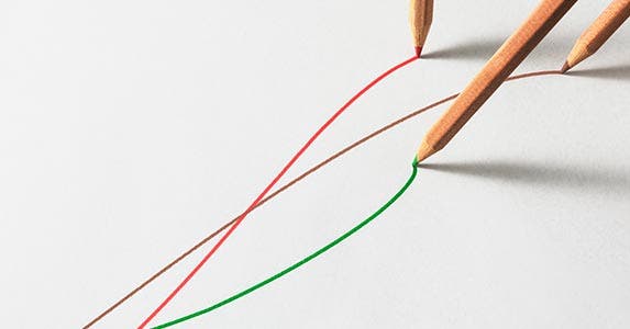 brown, red and green pencils on a white sheet of paper