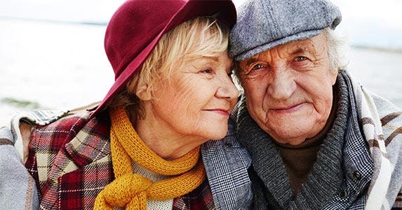 Elderly couple wearing hats and scarves