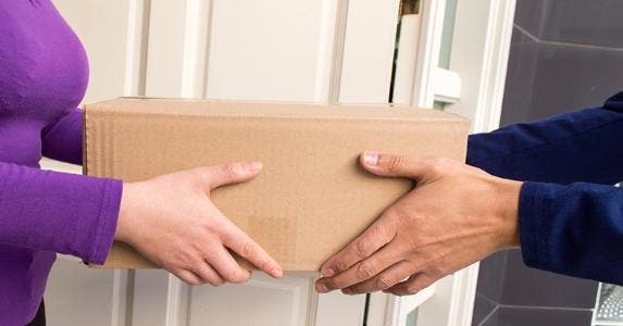 What if you're mailed merchandise you didn't order? Package being delivered to home | iStock.com/Manuel Faba Ortega