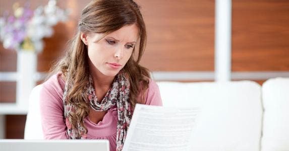 Woman looking at a letter © iStock