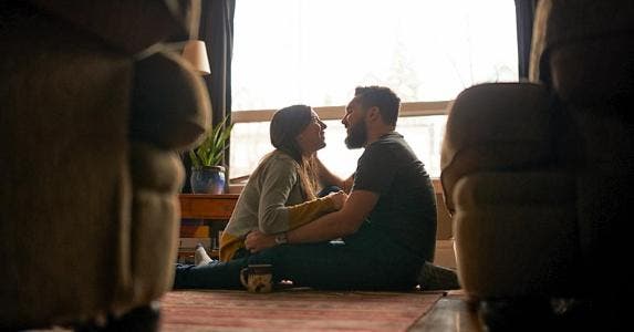 HomePath loan saves cash when buying foreclosure Couple in new home embracing in the living room | jeffbergen/Getty Images