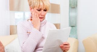 Older woman looking at document © Kzenon/Shutterstock.com