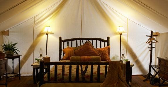 Tent interior with bed and lamps © iStock