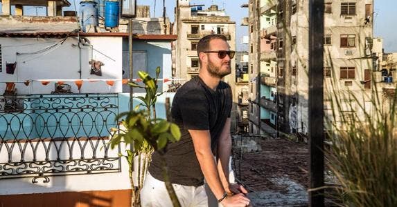 What you need to know for travel to Cuba Man looking at view from rooftop | Photo by Julio Gaggia