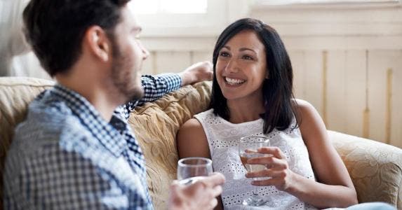 Find out: What is a conventional mortgage? Couple having wine on the couch | Morsa Images/DigitalVision/Getty Images