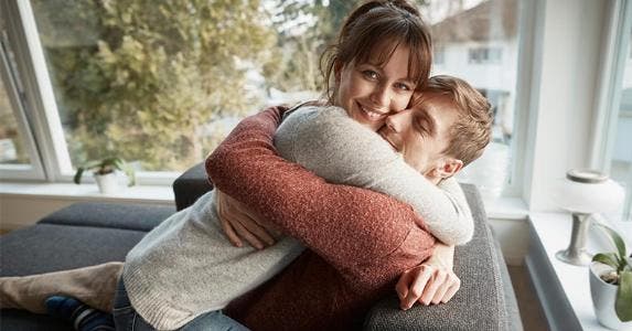 The toughest and easiest states for first-time homebuyers Couple hugging on couch in living room | Oliver Rossi/Getty Images