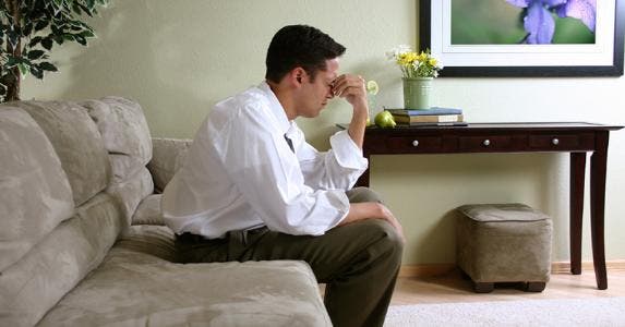 Man pinching the bridge of his nose © iStock