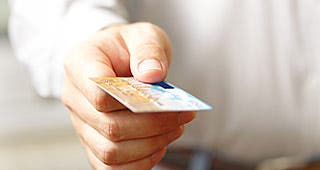 Man holding credit card © ievgen sosnytsky/Shutterstock.com