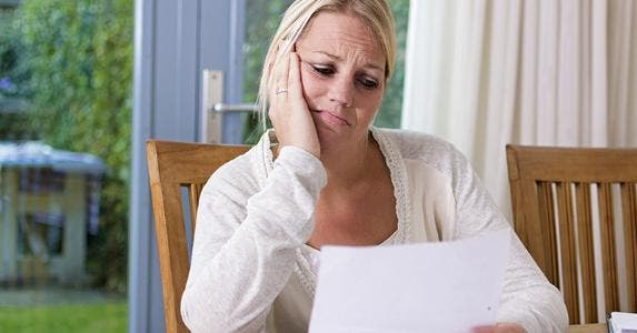 Woman looking sadly at paper © Twin Design/Shutterstock.com