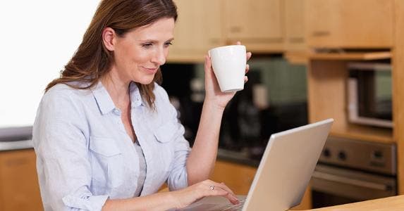 Woman using her laptop in kitchen © wavebreakmedia/Shutterstock.com
