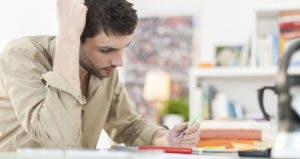 Man looking at paperwork © Jack Frog/Shutterstock.com