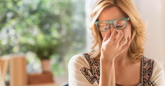 How to correct a credit report Stressed woman pinching bridge of nose | Tetra Images/Getty Images