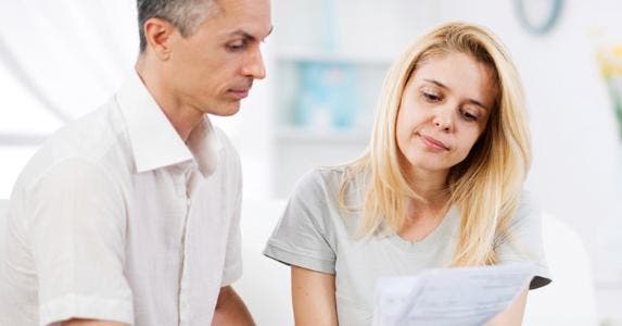 Reaffirm mortgage post-bankruptcy? Couple looking at document | iStock.com