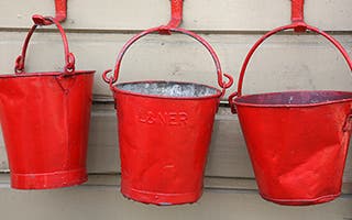 Three old red fire buckets © Shelli Jensen/Shutterstock.com