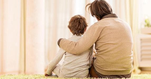 How ID theft threatens kids and teens Father and son sitting on rug in beige room | iStock.com/skynesher