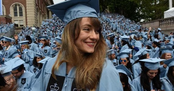 Millennials, employers think you're full of yourselves Graduating woman in blue cap and gown | TIMOTHY A CLARK/AFP/Getty Images