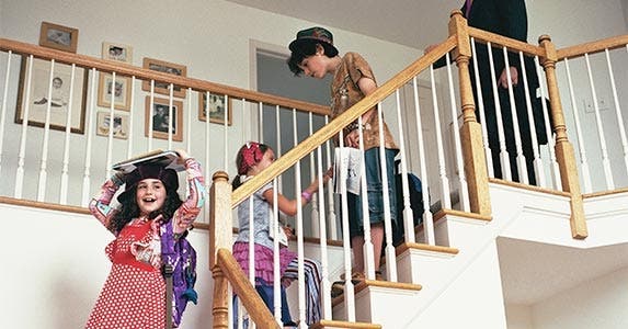 Family walking down the stairs in their home
