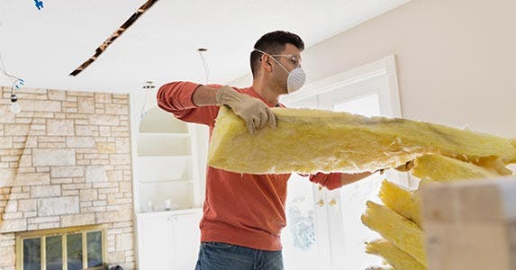 Man installing insulation