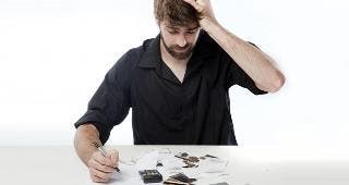Man with debt, paperwork © Danie Nel/Shutterstock.com