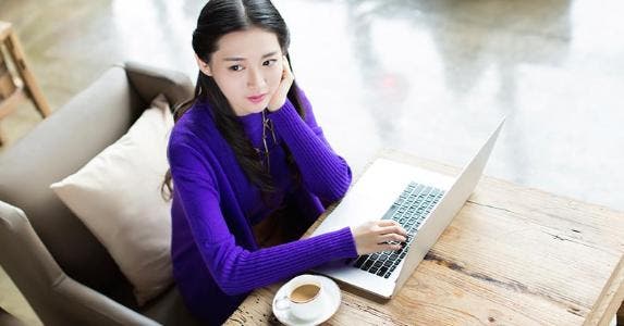 5 things young adults must know about credit Young woman in purple sweater using laptop computer | iStock.com/visionchina