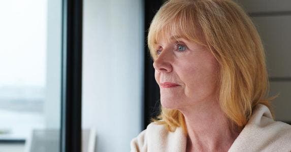 Woman looking out of her patio window © iStock