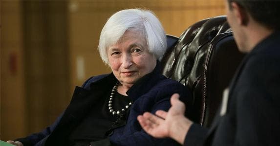 Will the Fed talk Trump, raise interest rates? Janet Yellen sitting on chair | Elijah Nouvelage/Getty Images