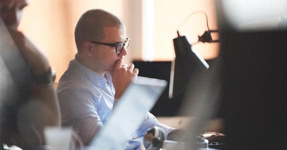 The risks and rewards of corporate bonds Young office worker, thinking © dotshock/Shutterstock.com
