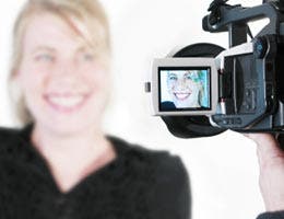 Woman smiling to a video camera