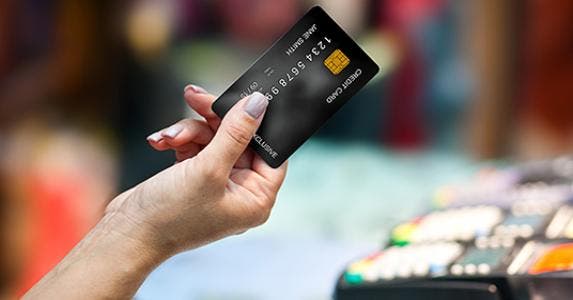 Woman's hand holding credit card in store © dean bertoncelj/Shutterstock.com