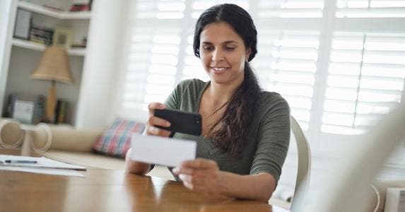 Woman taking picture of a check with her phone