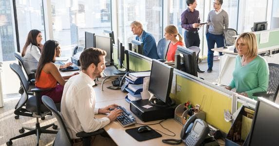 Employees working in open office © iStock