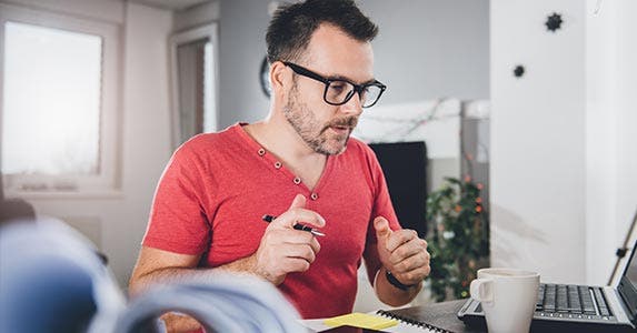 Man in glasses working at desk