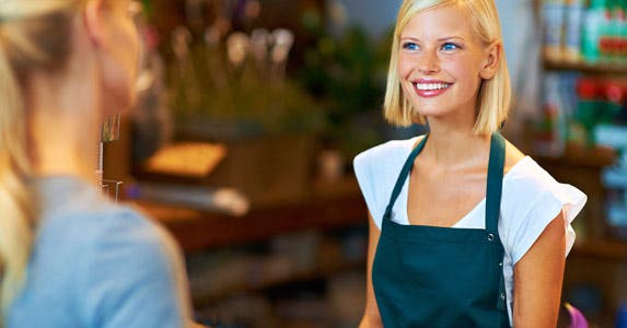 Cashier talking to customer at counter