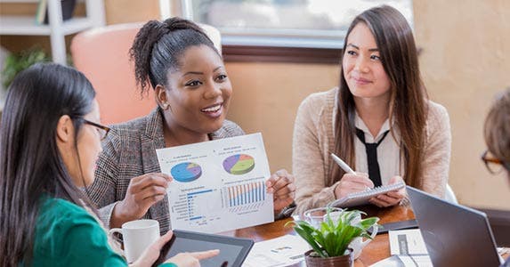 Adviser showing people at table a pie chart showing asset allocation