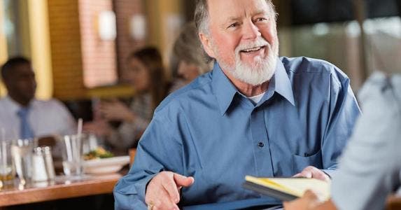 3 tips for senior citizens looking for part-time work Smiling mature man in job interview meeting | iStock.com/Steve Debenport