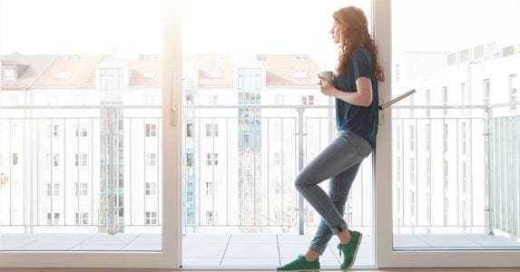 Nearly half of renters covet homeownership Millennial standing in frame of patio doorway | Westend61/Getty Images