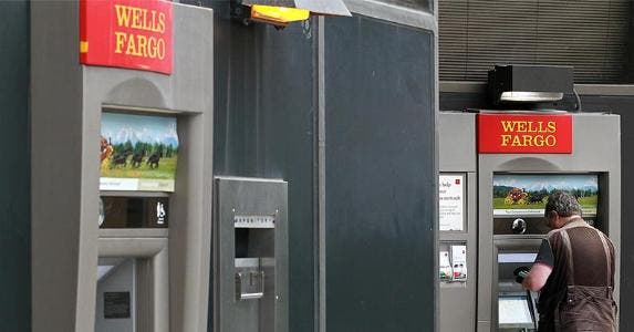 Meet a victim of the Wells Fargo sketchy practices Man withdrawing from an outdoor Wells Fargo ATM | Justin Sullivan/Getty Images