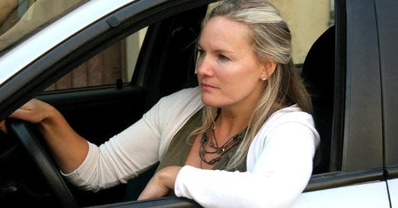 Woman looking out of driver's side window © iStock