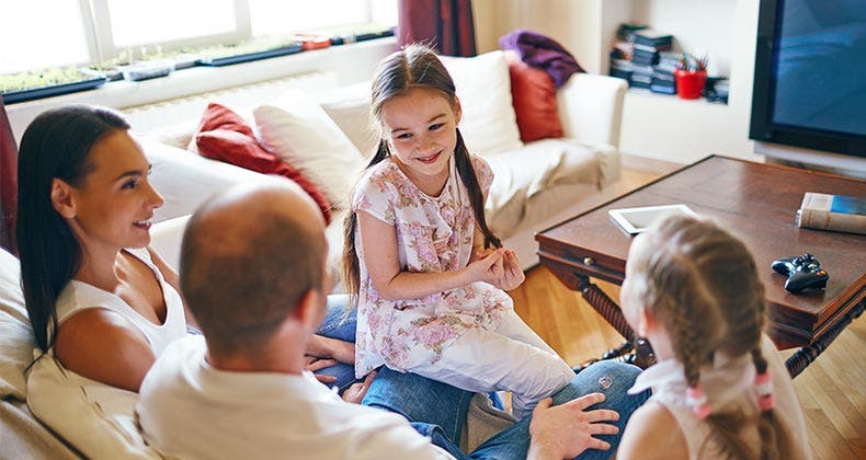 Is it smart to be a serial refinancer? Family talking in living room © Pressmaster/Shutterstock.com