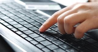 Hand pressing 'Y' key on keyboard © Alliance/Shutterstock.com