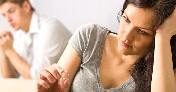 Man and woman sitting apart after fight © CandyBox Images/Shutterstock.com
