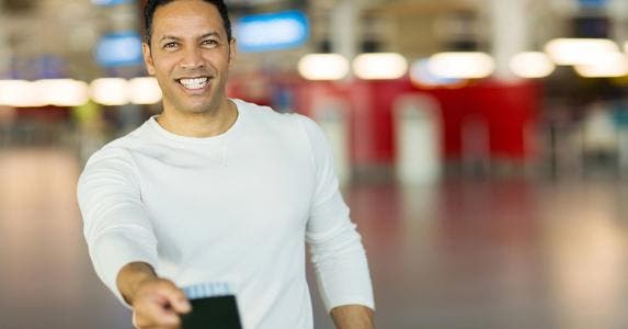 Man handing over his passport and ticket