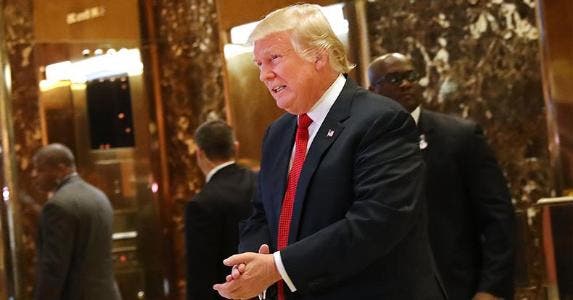 Will Trump help or hurt your finances? See Americans say Donald Trump in lobby with security | Spencer Platt/Getty Images